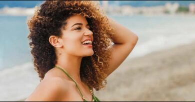 a girl on beach with curly hair