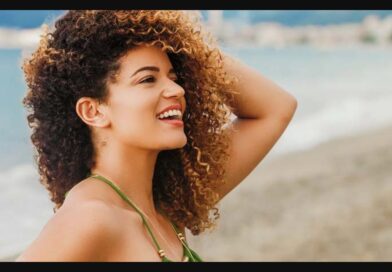 a girl on beach with curly hair