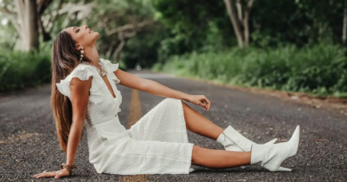 a girl in white dress modelling on the road